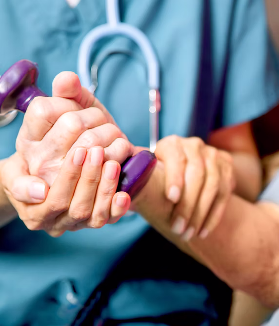 A healthcare worker checking a patient's pulse